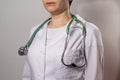 Green  stethoscope. A doctor in a white medical uniform holds a stethophonendoscope Royalty Free Stock Photo