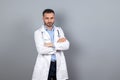 Doctor in white robe standing at the wall Royalty Free Stock Photo