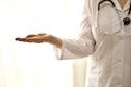 The doctor in a white robe stands, closeup, the left side of the person on the right, with empty palm showing anything