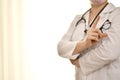 The doctor in a white robe with a stethoscope and glasses, shows a gesture of warning, recommendations, index finger Royalty Free Stock Photo