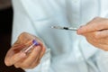 Doctor in a white surgical gown and blue mask holds in hands a medical syringe and bottle with insulin for diabetes. Sugar