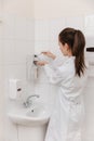 The doctor in white uniform disinfects his hands. Surgeon washing hands hospital concept. The nurse washes her hands Royalty Free Stock Photo