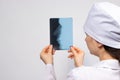 A doctor in white uniform examines an X-ray of a patient with a broken nose bone. Nose injury, crack or fracture - radiology and Royalty Free Stock Photo