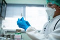 Doctor in a white uniform wearing a face and face shield prepares a syringe to vaccinate people in the medical center Royalty Free Stock Photo