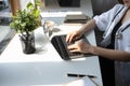 Doctor in white uniform is working with laptop and documents in medical office.