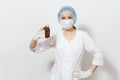 Doctor woman in face mask, sterile hat, gloves holding liquid medicine in bottle isolated on white background. Female Royalty Free Stock Photo