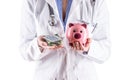 Doctor woman hands holding pills and piggy bank