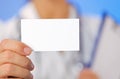 Doctor (woman) holding blank business card Royalty Free Stock Photo