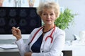 Doctor woman holds pen on background an x-ray