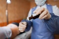 Doctor woman holds tweezers in her hands and drips on the cotton wool antibacterial solution. It is used in the treatment of Royalty Free Stock Photo