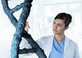 Doctor woman interacting with 3D DNA strand Royalty Free Stock Photo