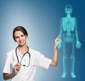 Doctor woman pointing on drawing human skeleton. Royalty Free Stock Photo