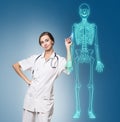 Doctor woman pointing on drawing human skeleton. Royalty Free Stock Photo