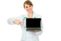 Doctor woman pointing on laptop with blank screen Royalty Free Stock Photo