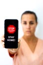 Doctor woman showing corona virus warning on her cell phone Royalty Free Stock Photo