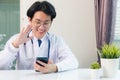 Doctor woman smiling using working with smart mobile phone Royalty Free Stock Photo