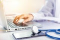 Doctor woman typing information of patient prescription from paperwork medical history form into laptop Royalty Free Stock Photo