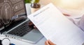 Doctor woman typing information of patient prescription from paperwork medical history form into laptop Royalty Free Stock Photo