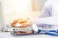 Doctor woman typing information of patient prescription from paperwork medical history form into laptop Royalty Free Stock Photo