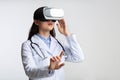 Doctor Woman Using Virtual Reality Headset Standing, Studio Shot Royalty Free Stock Photo