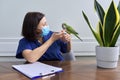 Doctor woman veterinarian examining a green Quaker parrot