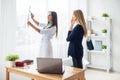 Doctor woman with white labcoat looking at x-ray Royalty Free Stock Photo