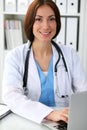 Doctor woman at work. Physician typing on laptop computer. Medicine, healthcare concept