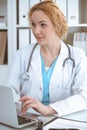 Doctor woman at work. Physician typing on laptop computer. Medicine, healthcare concept