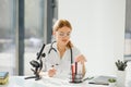 Doctor woman working a microscope. Female scientist looking through a microscope in lab. Student looking in a microscope Royalty Free Stock Photo