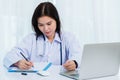 Doctor woman writing something on paperwork or clipboard white paper Royalty Free Stock Photo