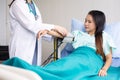 Doctor woman checking to her asian patient blood pressure in hospital,Heart rate pressure gauge Royalty Free Stock Photo