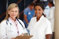 Doctor, women and teamwork portrait in healthcare with clipboard, health information and smile in hospital. Medical Royalty Free Stock Photo