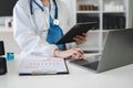 Doctor work on digital tablet healthcare doctor technology tablet using computer in a modern office in the morning at the desk Royalty Free Stock Photo