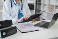 Doctor work on digital tablet healthcare doctor technology tablet using computer in a modern office in the morning at the desk Royalty Free Stock Photo
