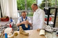 Doctor and worker preparing orthopedic insoles for a patient