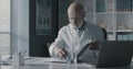 Doctor checking medical records in his office Royalty Free Stock Photo