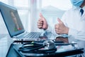 Doctor working on the laptop computer, Close up of a general practitioner in video conferencing with a patient on a laptop Royalty Free Stock Photo