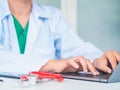 Doctor working with laptop computer in her office. Health care a Royalty Free Stock Photo