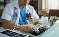 Doctor working on laptop computer and medical stethoscope on clipboard on desk, electronics medical record system EMRs concept Royalty Free Stock Photo