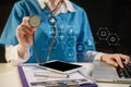 Doctor working on laptop computer and tablet and medical stethoscope on clipboard on desk. Royalty Free Stock Photo