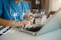 Doctor working on laptop computer and tablet and medical stethoscope on clipboard on desk Royalty Free Stock Photo