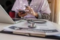 Doctor working with laptop computer and writing on paperwork. Royalty Free Stock Photo