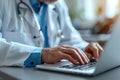 Doctor working with laptop computer and writing on paperwork. Hospital background Royalty Free Stock Photo