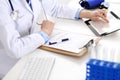 Doctor working table. Woman physician using tablet computer while sitting in hospital office close-up. Healthcare Royalty Free Stock Photo