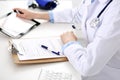 Doctor working table. Woman physician using tablet computer while sitting in hospital office close-up. Healthcare Royalty Free Stock Photo