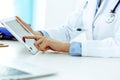 Doctor working table. Woman physician using tablet computer while sitting in hospital office close-up. Healthcare Royalty Free Stock Photo