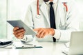 Doctor working on tablet computer in the hospital. Royalty Free Stock Photo