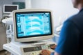 Doctor working with ultrasound machine in hospital. Generative AI