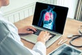 Doctor working with x-ray of lungs on a laptop. Cancer of lungs and cigarette prevention