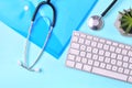 Doctor workplace with medical stethoscope, computer keyboard and folder. Royalty Free Stock Photo